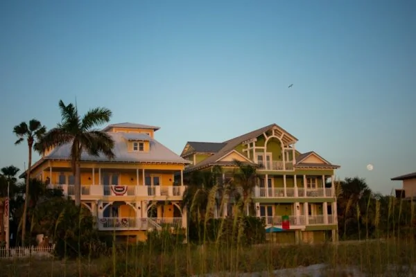 A large yellow house sitting on top of a lush green field