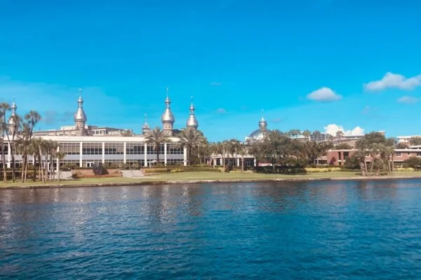 a body of water with a building in the background