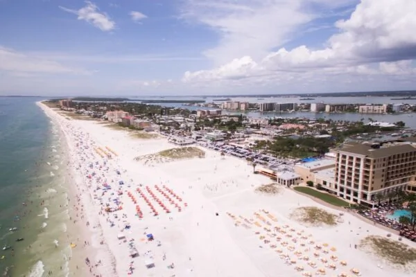 aerial photography of people on the beach across buildings at daytime