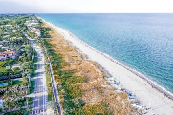 a beach with a road and buildings along it