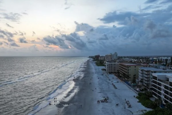 an aerial view of a beach and a city