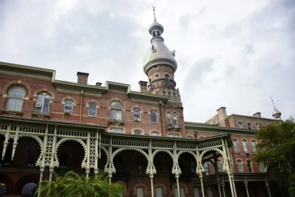 Historic brick building with ornate balconies and tower